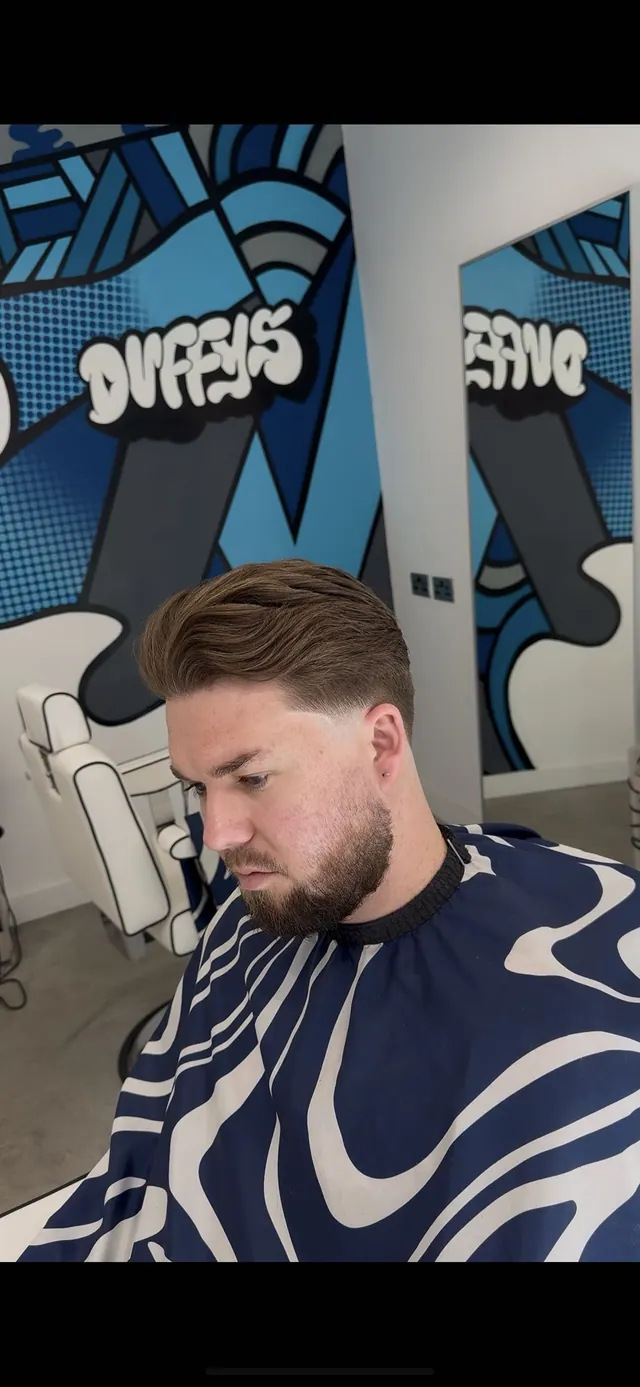 A textured side-swept cut with a beard